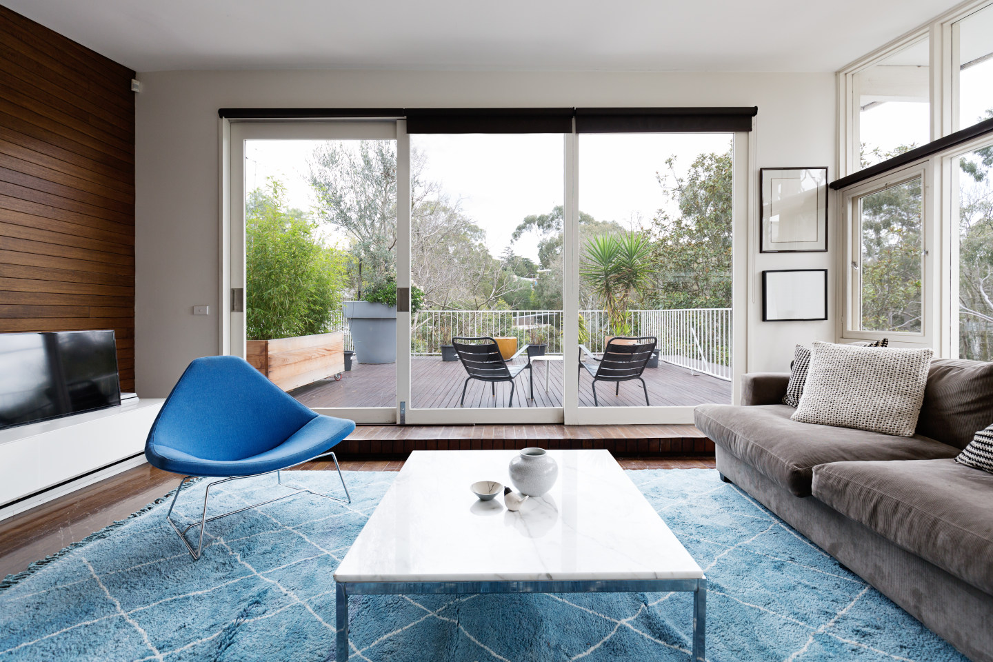 Luxury scandinavian styled living room with outlook to terrace and gum trees