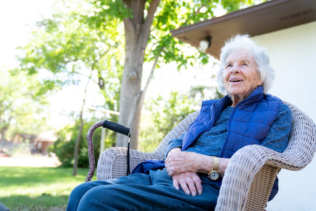 Beautiful 90 Plus Year-Old Elderly Senior Caucasian Woman Sitting Outdoors in Shade in the the Summer